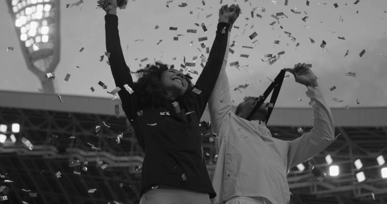 Black,Male,And,Female,Athletes,Celebrate,A,Win,On,A Black Male and Female Athletes Celebrate a Win on a podium after receiving gold medal